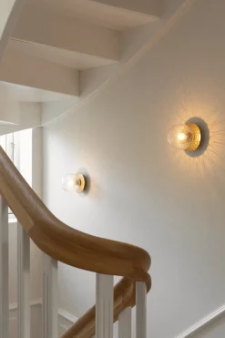 Nuura Liila 1 vägg-/taklampa, liten, nordic gold - klar optik